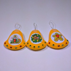 three yellow christmas tree bell ornaments