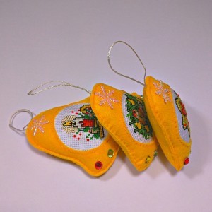 three yellow christmas tree bell ornaments